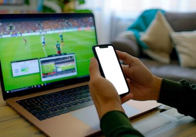 man-engaged-online-betting-soccer-match-using-laptop-smartphone_128034-3714