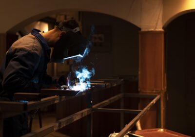 man-with-mask-welding-metal-atelier