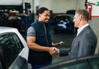 happy-african-american-car-repairman-greeting-with-male-customer-auto-repair-shop-1
